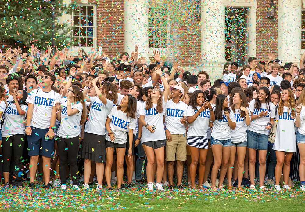 Duke students throwing up confetti. Full of joy and excitement.