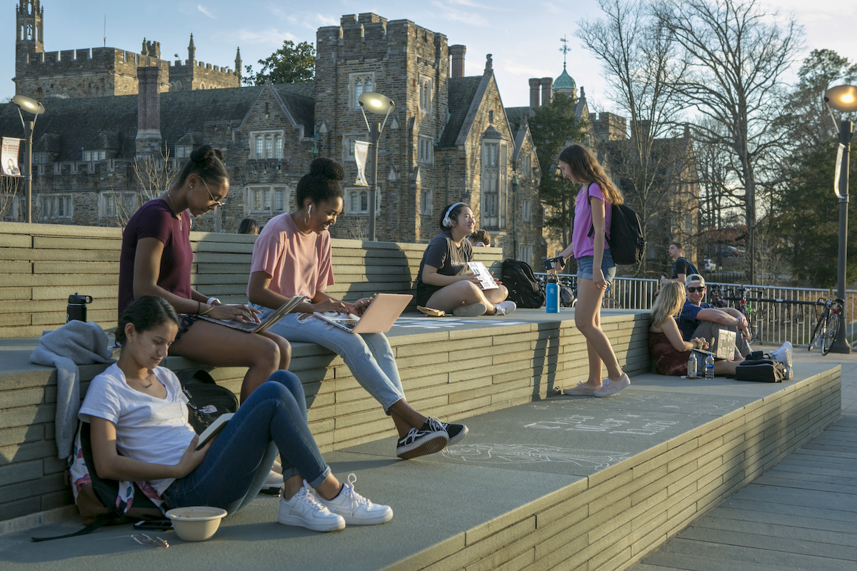 Duke students enjoy a warm and sunny February afternoon studying and socializing on the Bryan Center Plaza.
