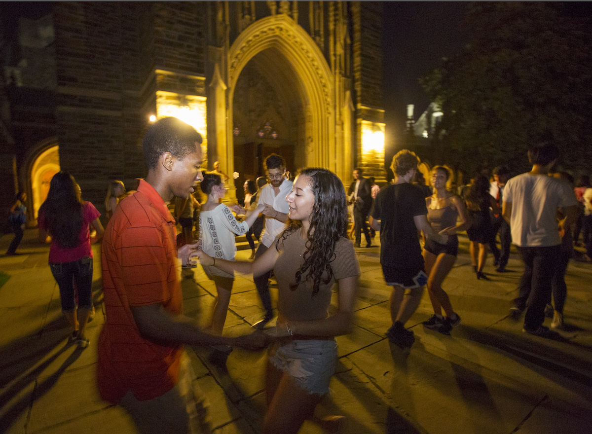 Students salsa dance in front of Duke Chapel after a short demo and lesson from members of Sabrosura