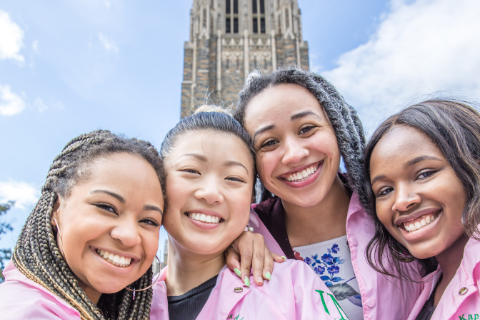 group of four alpha kappa alpha students smiling in front of the duke chapel