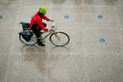 biker in the rain on west campus