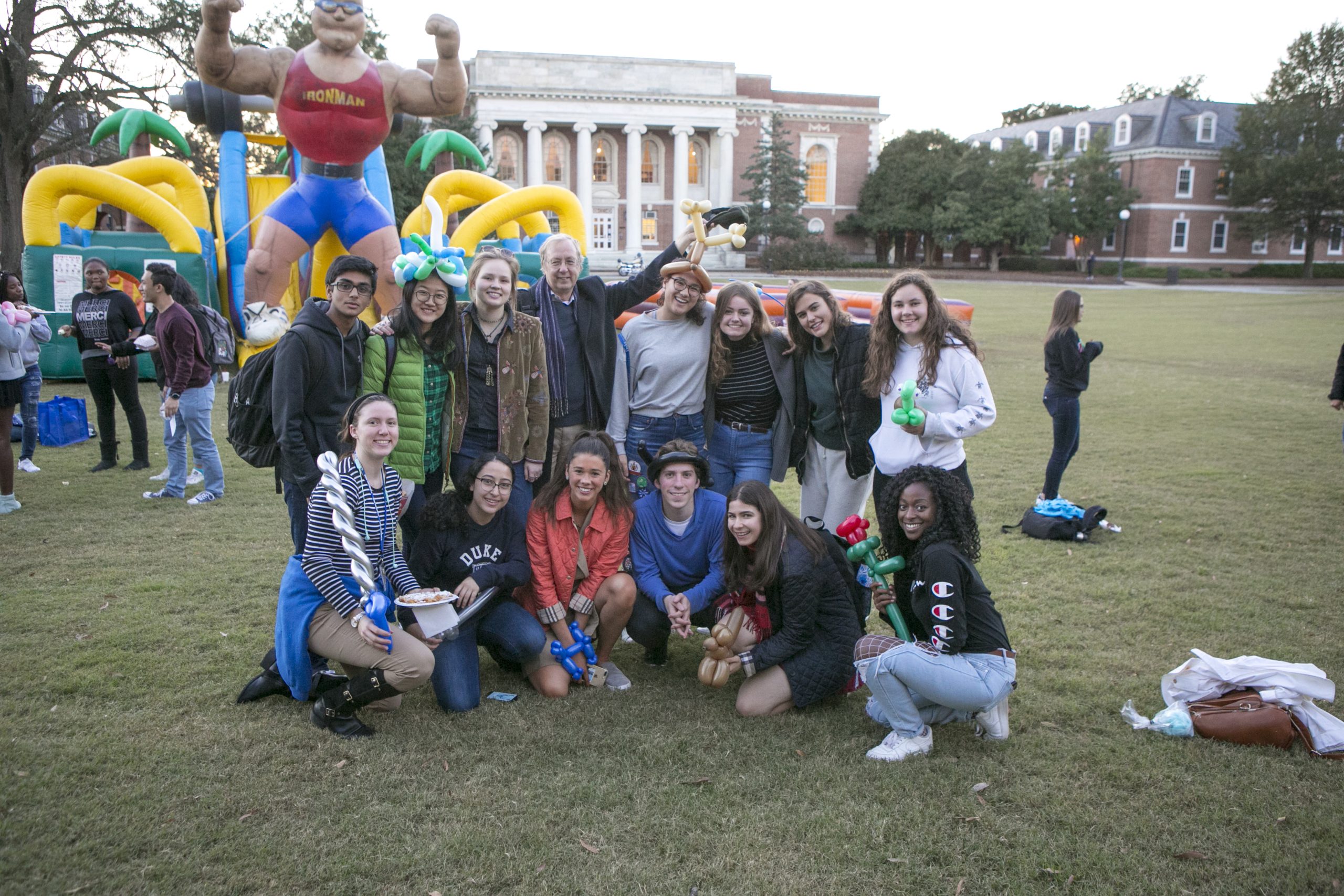 several students posing in front of an inflatable ride