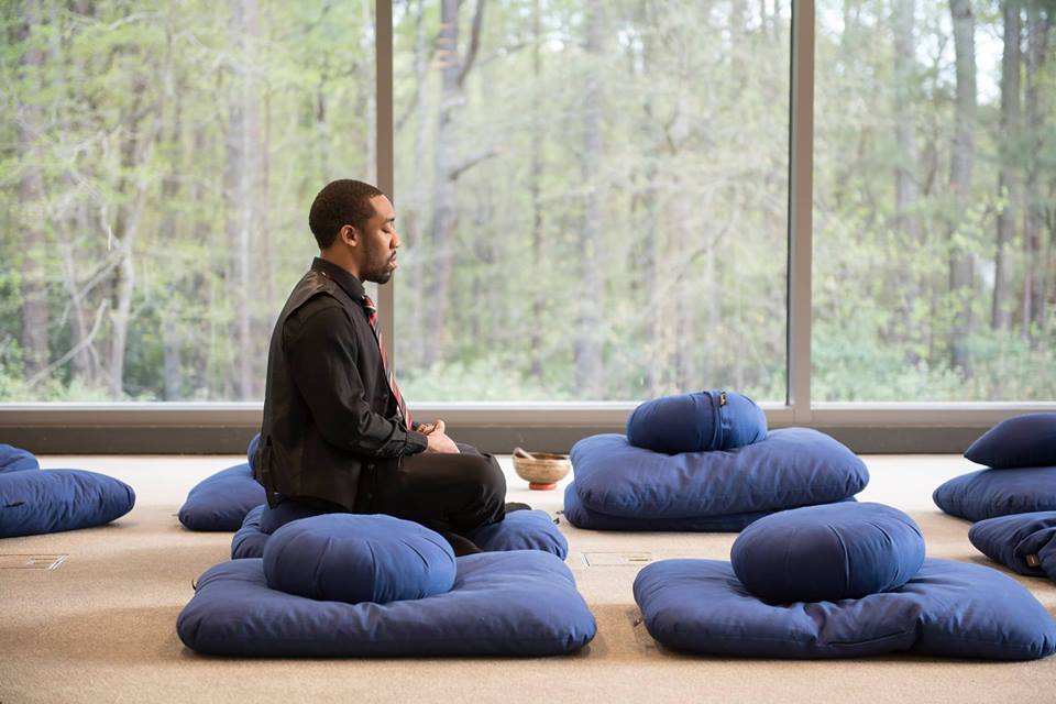 Student Meditating on pillows