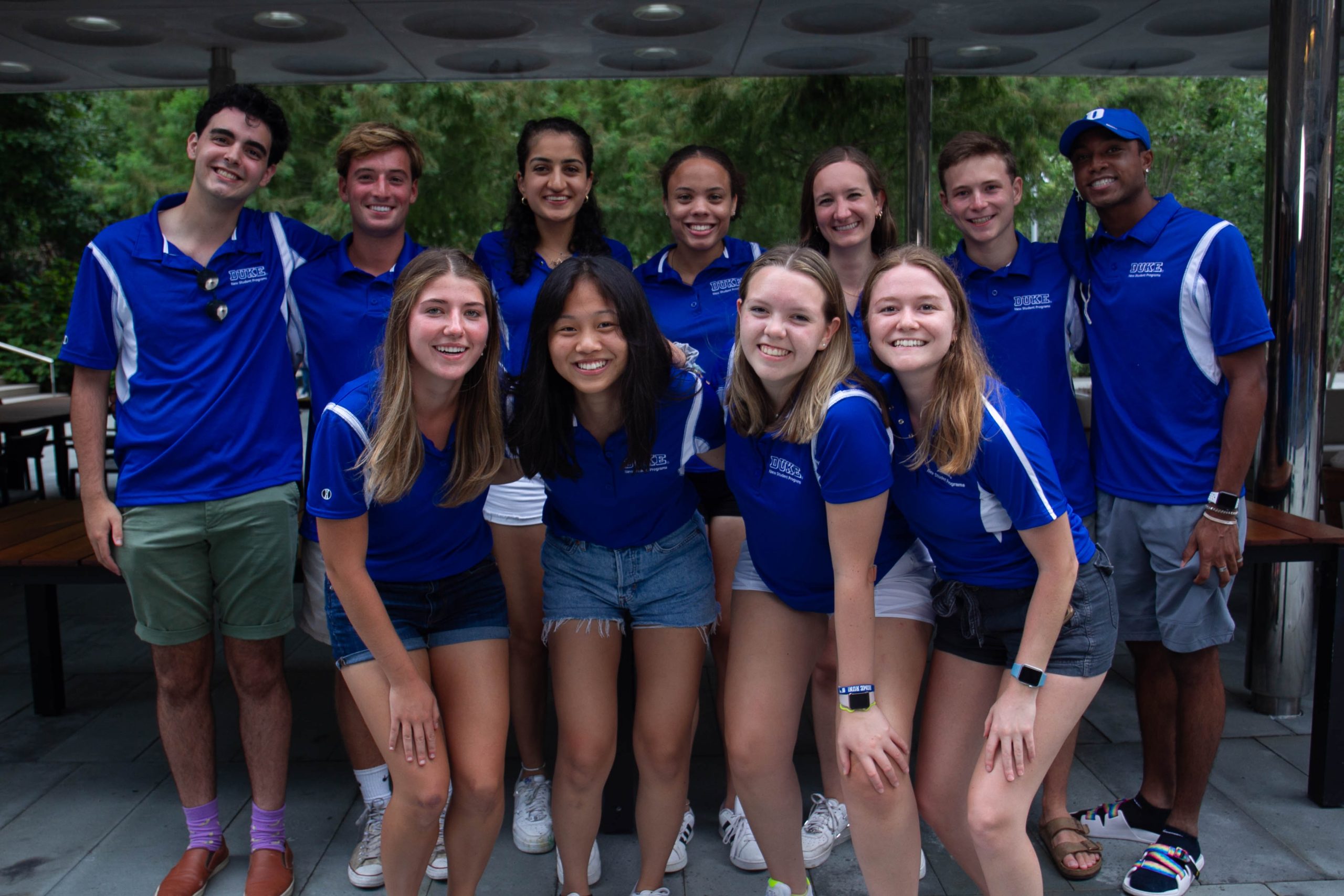 orientation leaders in blue polos pose
