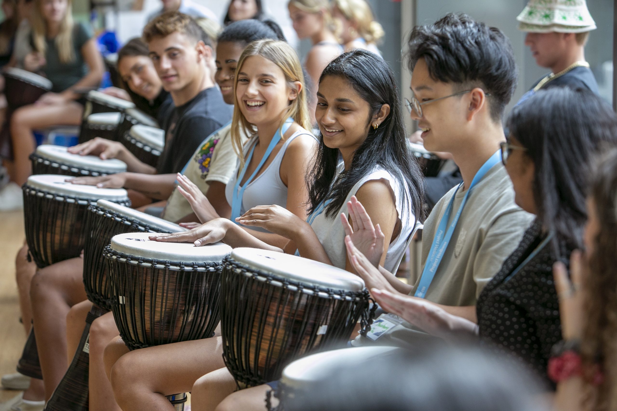 Duke first-year students in Project Wellness participate in a drum circle activity designed to make them feel comfortable expressing themselves and bond together in the Student Wellness Center.