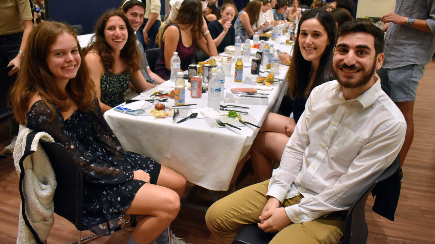 Jewish students eating a meal together