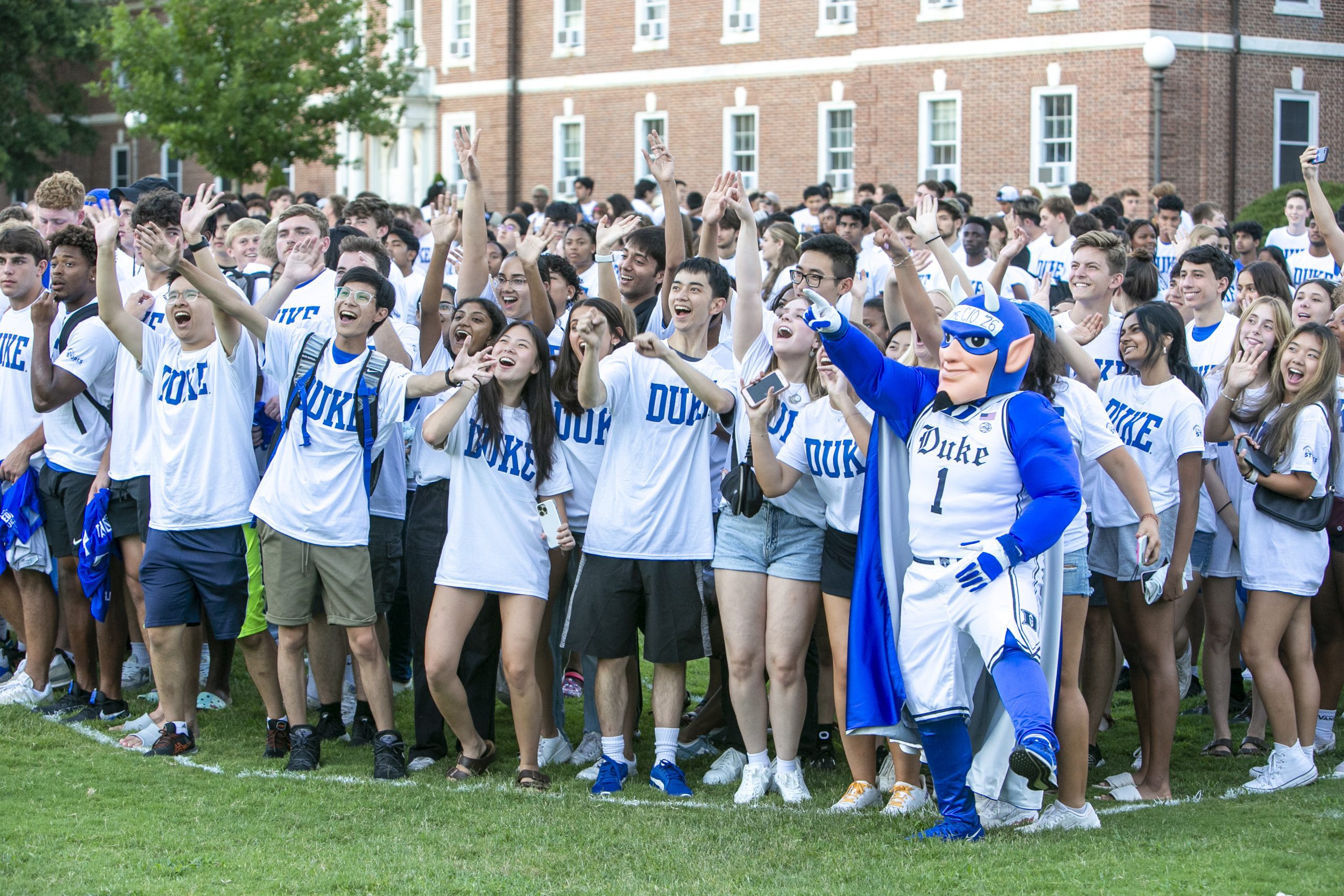 Class of 2026 smiling for photo with the Duke Blue Devil