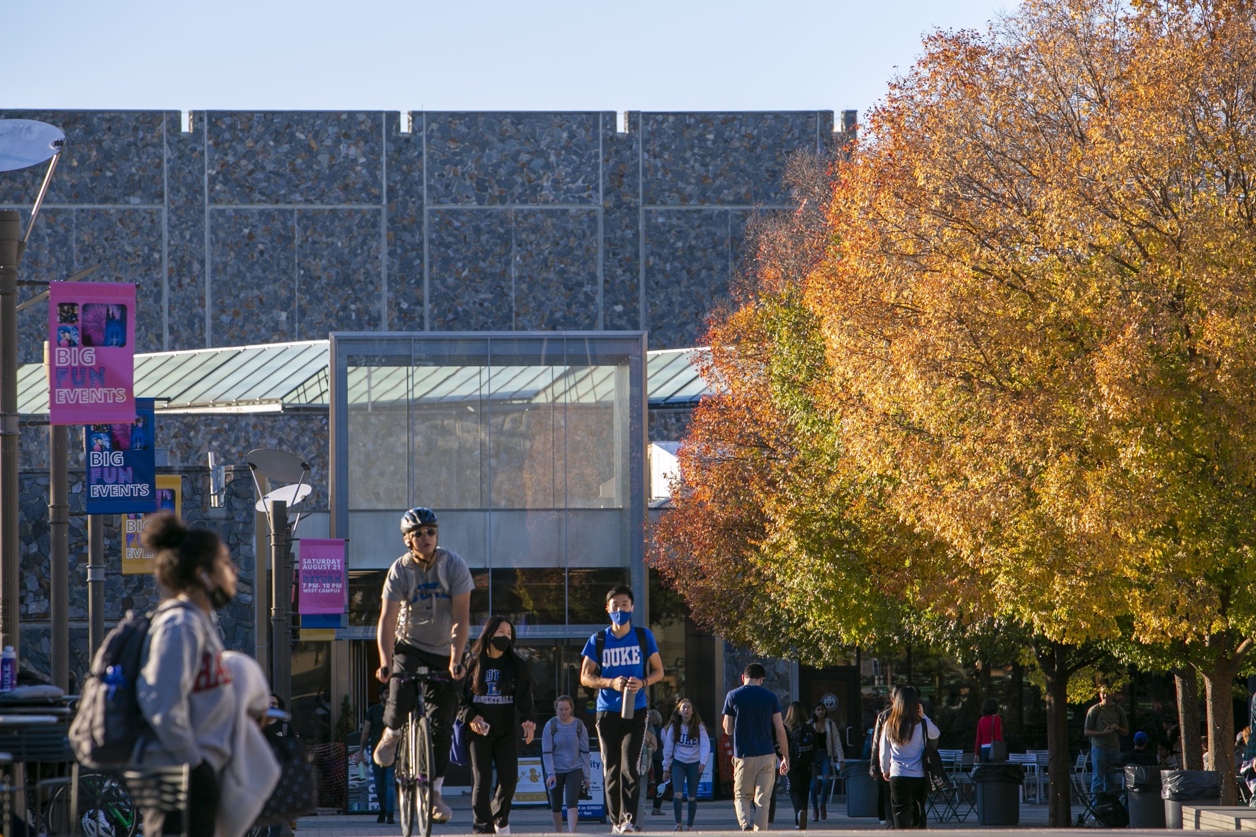 students walk outside Bryan Center in the fall
