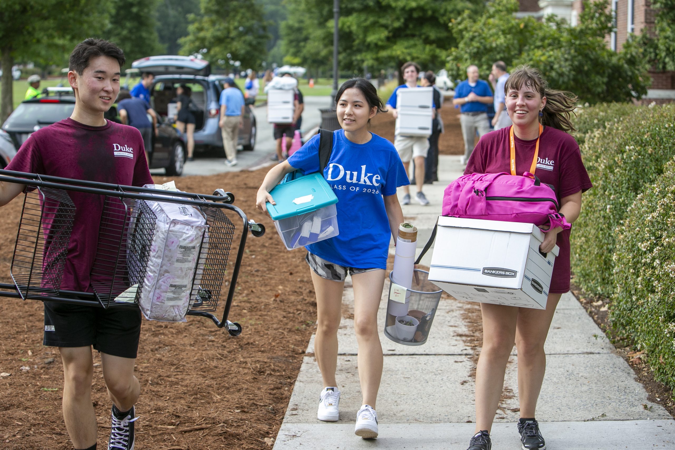 Duke first-year student Lisa Zhang, center, moves into Pegram Residence Hall as orientation leaders Alan Wang, left, and Eliana Durkee, both sophomores, help move her stuff, on Sat. Aug. 20, 2022.