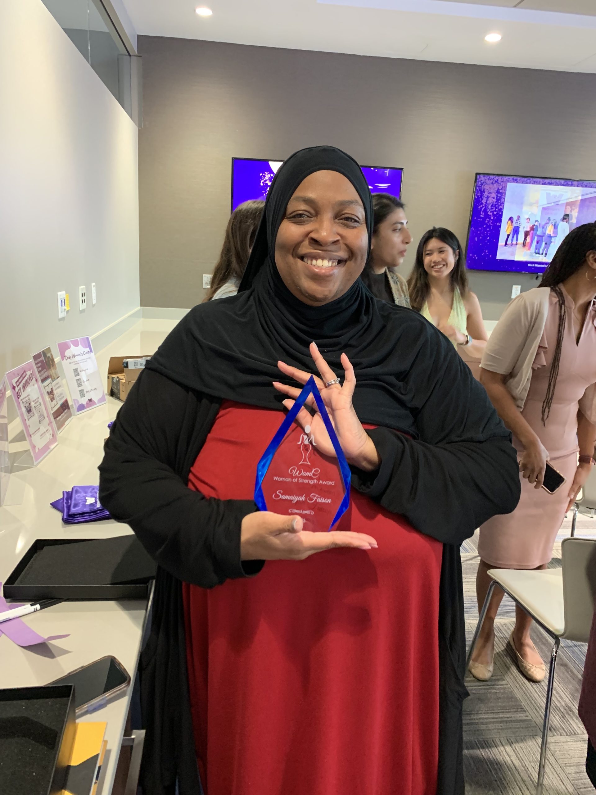 Samaiyah Faison holding her glass award