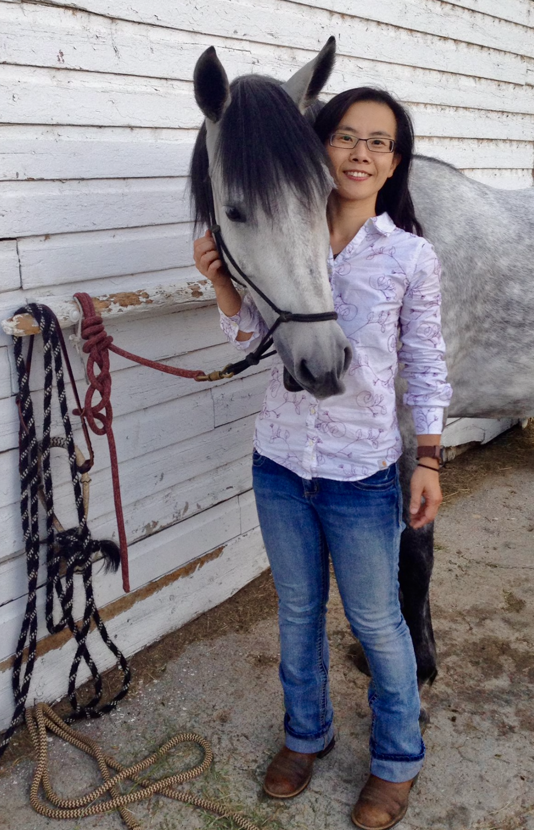 Ping-Tzu Lee stands next to a horse