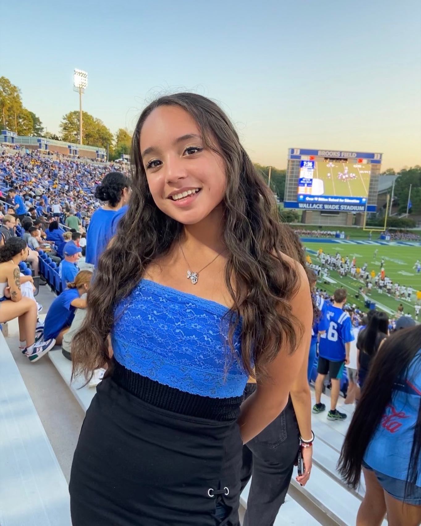 Cristal at a football game wearing blue and black