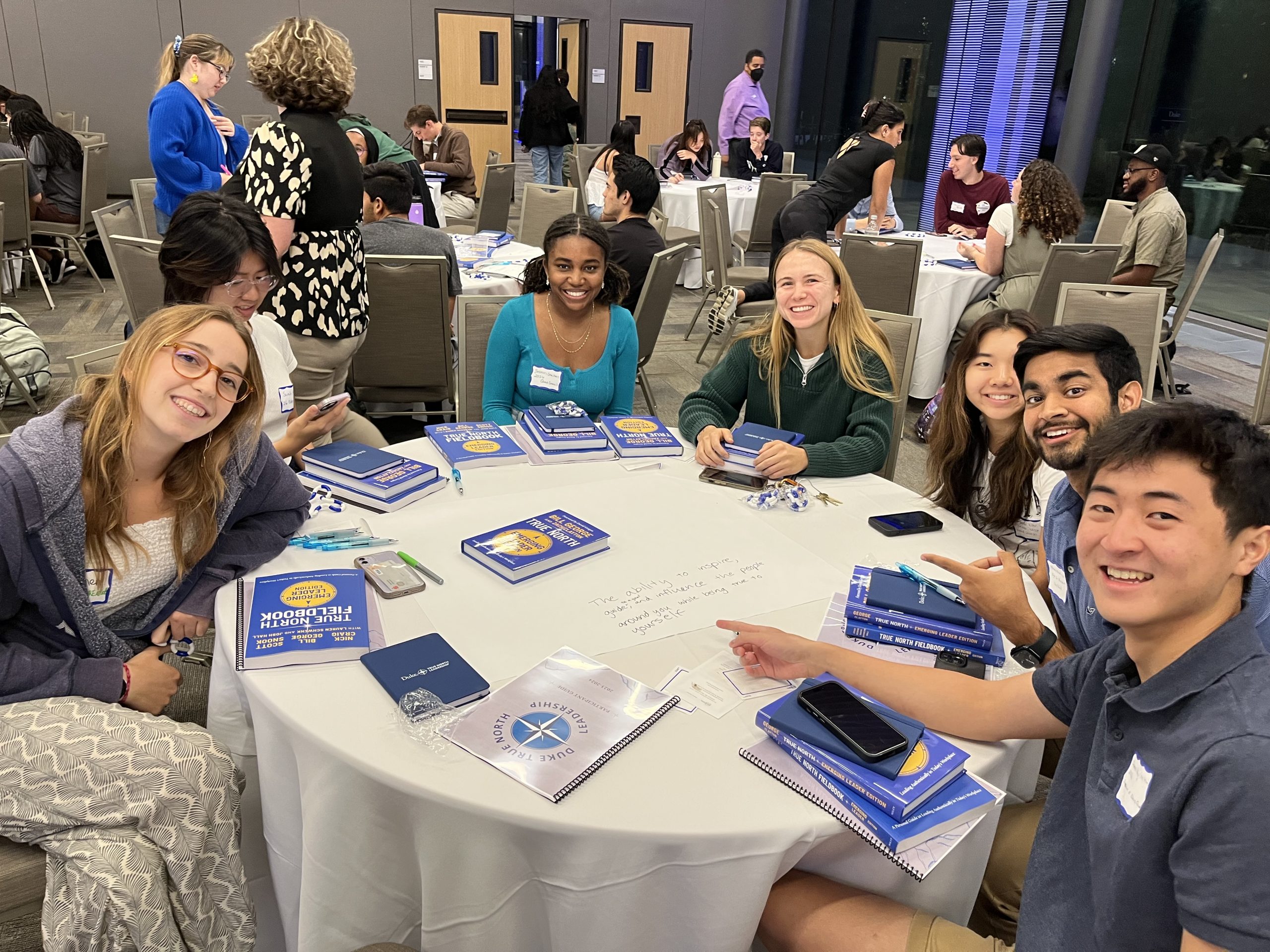 students sit around a table at a True North Leadership event