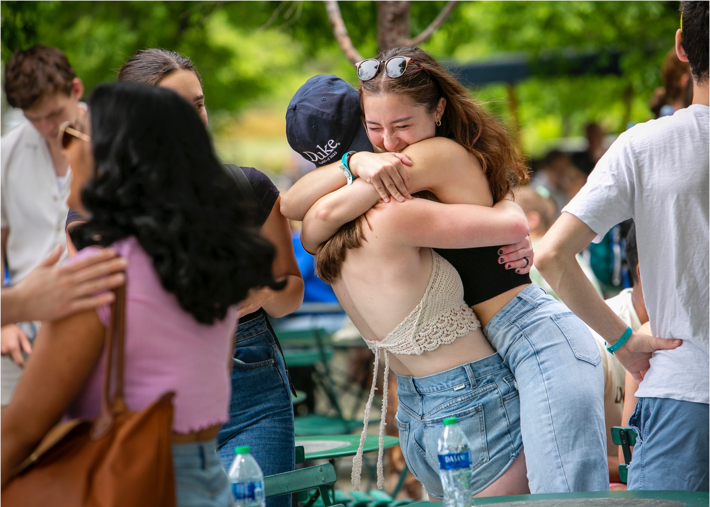 students embracing at an outdoor function