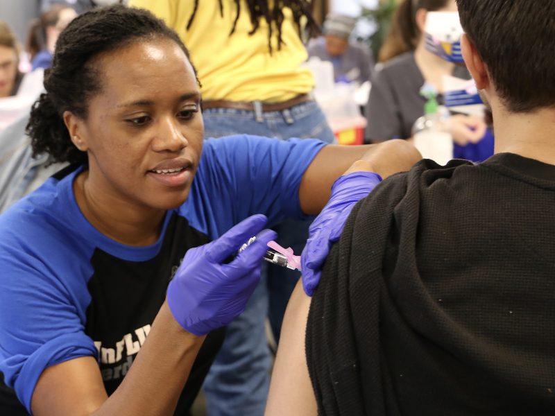 A nurse gives a Duke student a flu shot.